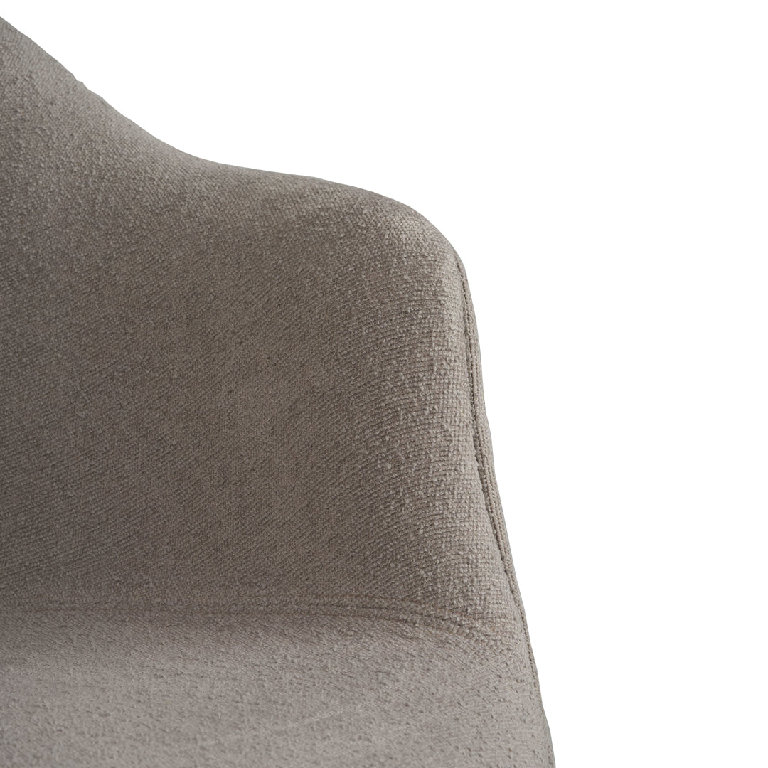 Soft grey upholstered chair with a smooth, textured finish, showcasing a modern, minimalist design.
