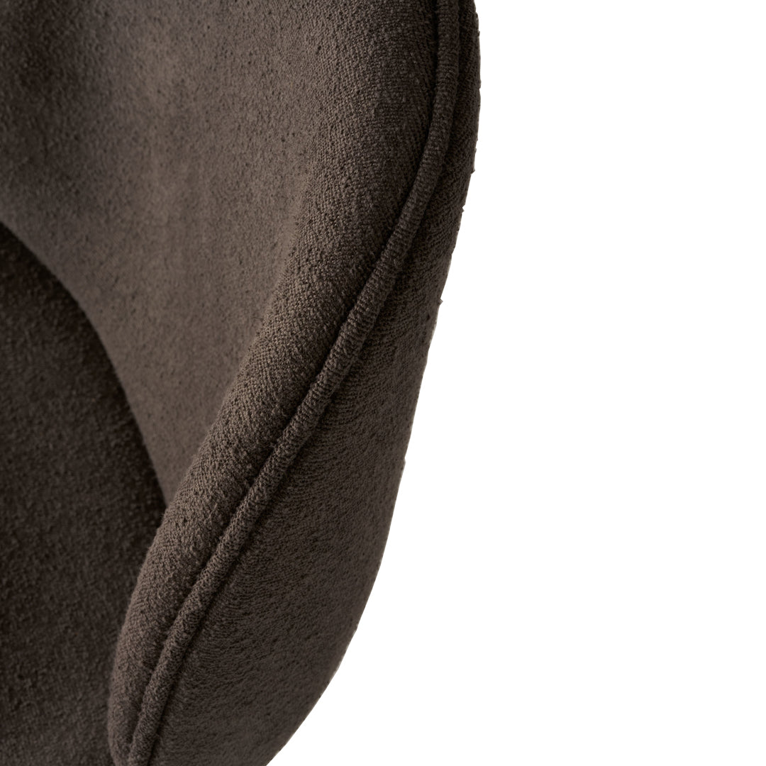 Brown textured fabric with smooth curves, showcasing a minimalist design and rich color depth.