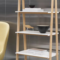 Natural wood shelf with white shelves and a sleek black bowl, showcasing modern, minimalist design.