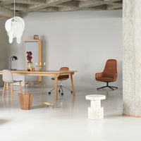 Modern workspace featuring warm wood tones, taupe and brown accents, with light gray walls and minimalist decor.