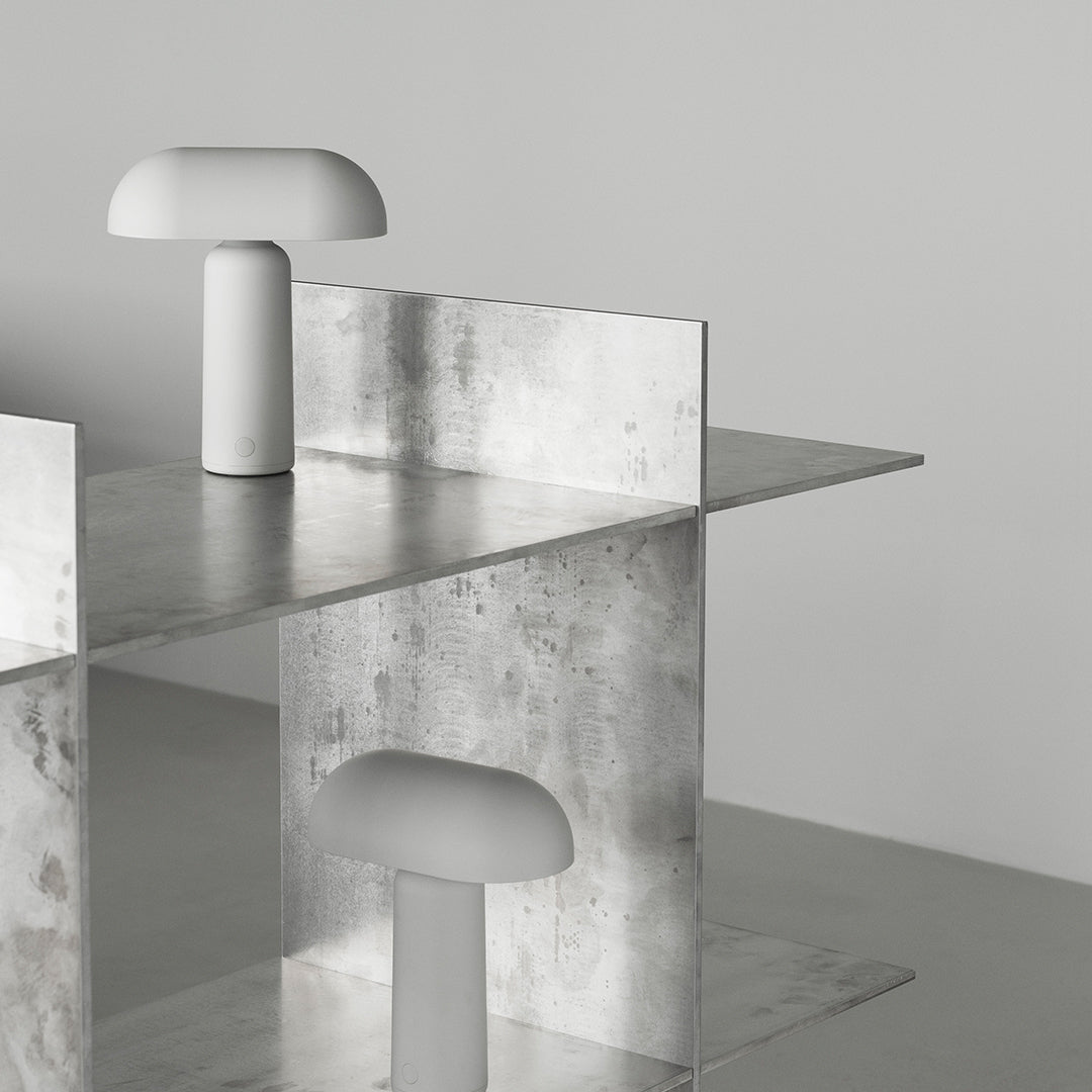 Sleek metallic structure with a smooth gray surface and minimalistic white lamp accents, featuring modern geometric patterns.