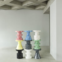 Colorful stacked side tables in red, blue, yellow, green, black, and white, featuring unique patterns and designs.
