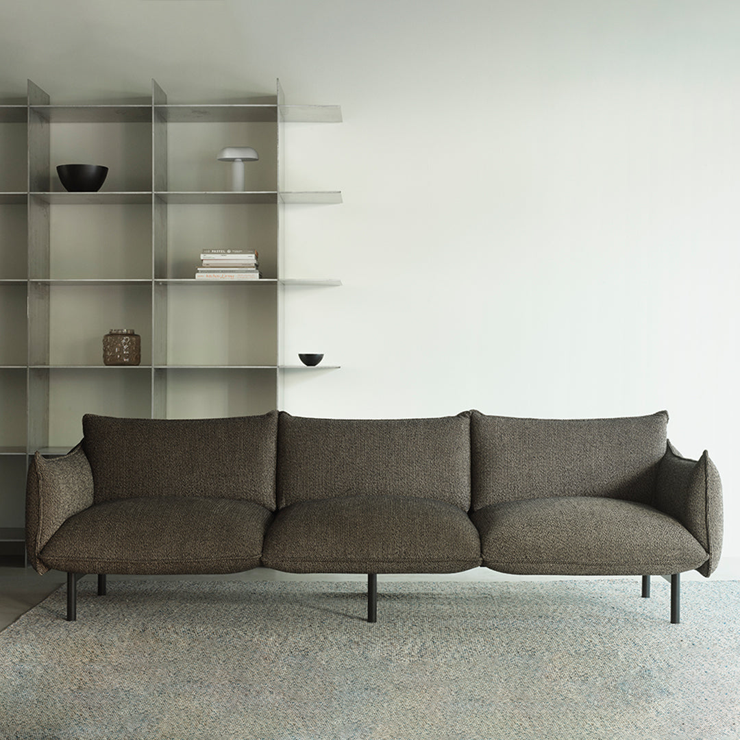 Brown textured sofa with sleek lines, paired against a minimalist backdrop and neutral color palette.