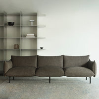 Brown textured sofa with sleek lines, paired against a minimalist backdrop and neutral color palette.