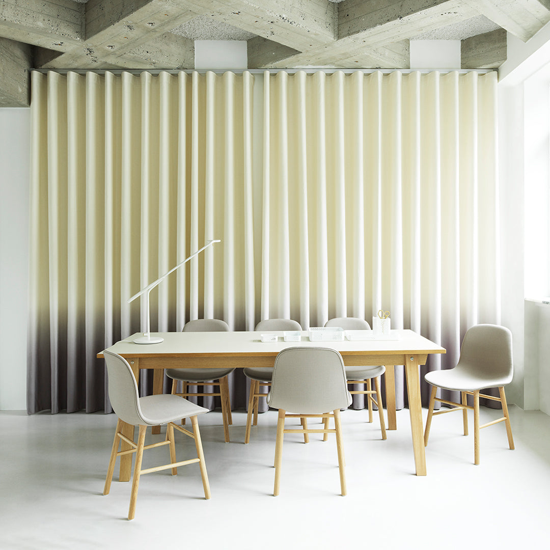 "Beige and cream gradient wall panel with subtle textured stripes in a modern dining setting."
