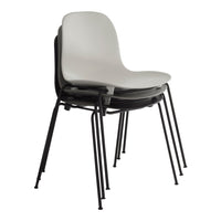 Stacked chairs in matte white and black with sleek, minimalist design on black metal legs.