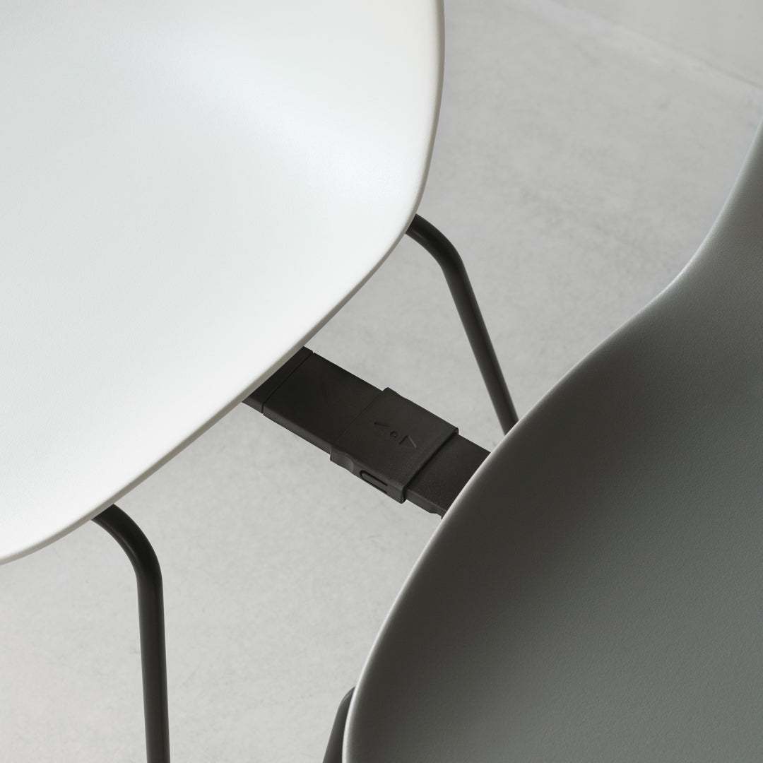 Modern chair in sleek white and muted gray with minimalist design and contrasting legs. Perfect for contemporary spaces.