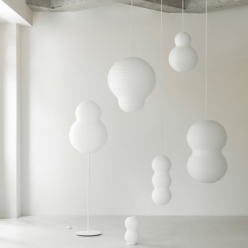 White hanging decor in various bubble shapes and sizes against a minimalist light background. Ideal for modern interiors.