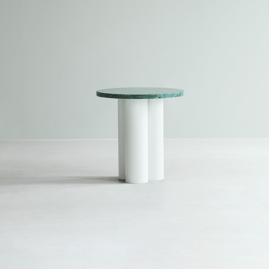Round tabletop in green marble with a sleek white cylindrical base, perfect for modern decor.