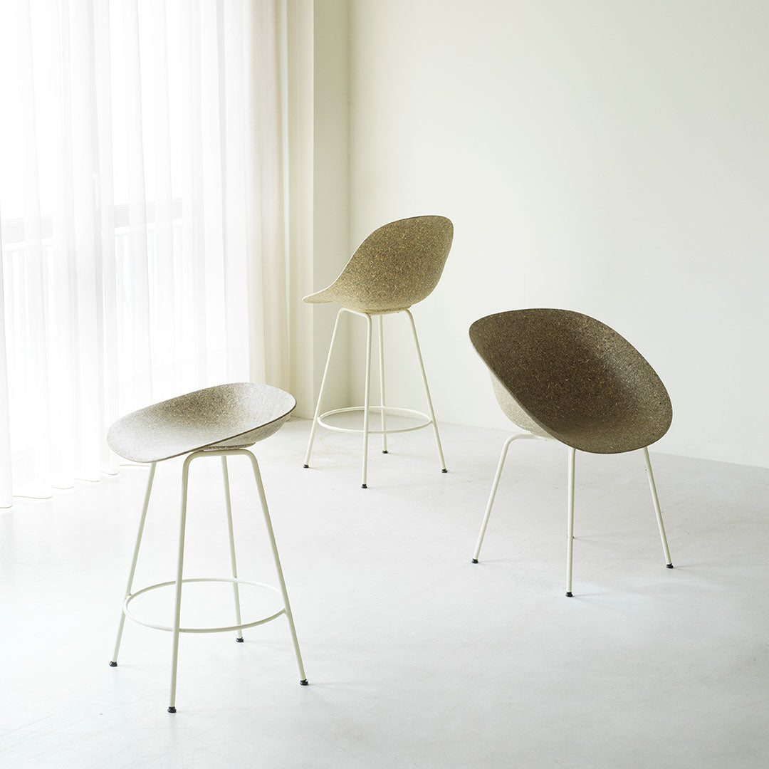 Modern chairs in soft beige tones, featuring sleek curved seats and light-colored legs, set against a minimalistic backdrop.
