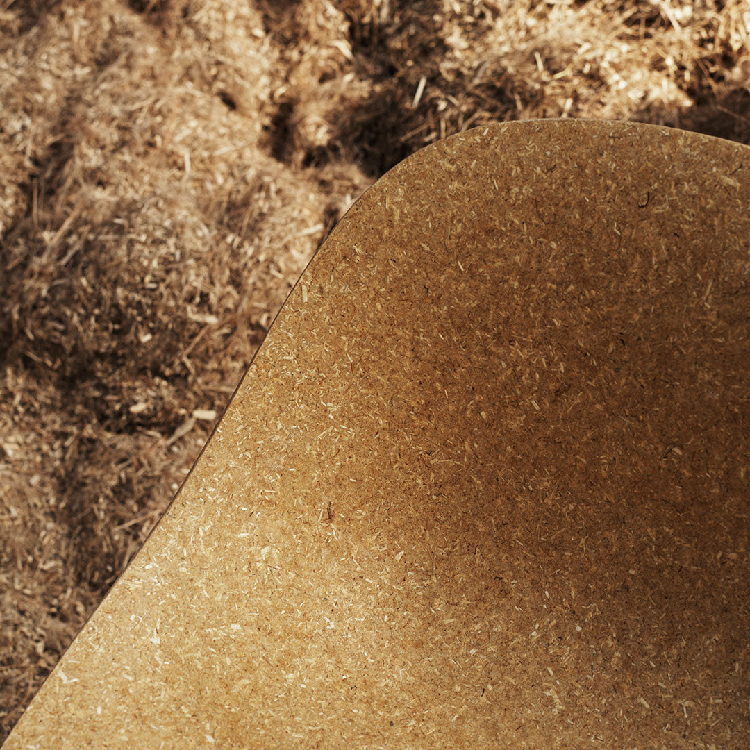 Natural brown texture with subtle curves, set against earthy brown mulch background. Ideal for home decor or gardening.