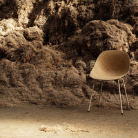 Brown ergonomic chair against a textured, earthy background of natural fibers and soft hues. Perfect for modern decor.