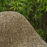 Natural brown textured surface with a soft curve, set against vibrant green plant backdrop. Perfect for eco-friendly decor.