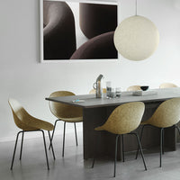 Modern dining room featuring beige molded chairs, a sleek gray table, and a large round light fixture.