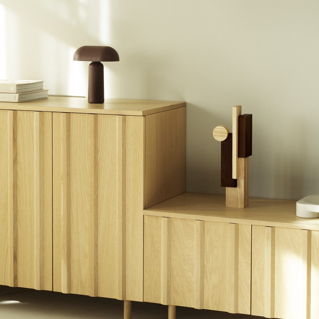 Wooden furniture in light oak with brown and beige decorative accents, featuring textured vertical patterns.
