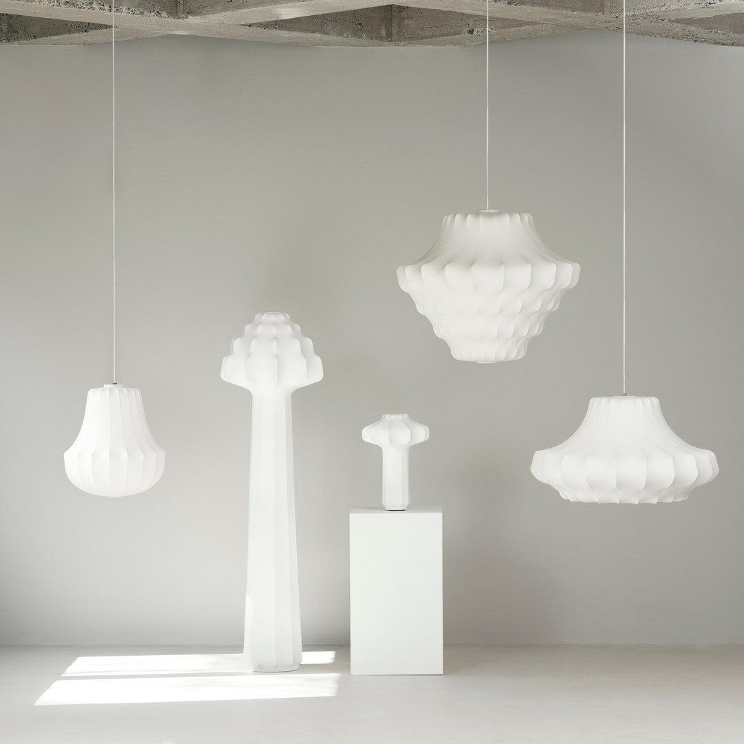 Minimalist white lamps with textured patterns in various shapes, enhancing modern decor aesthetics.