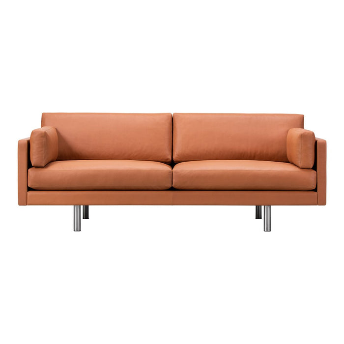 Modern orange sofa with clean lines and plush cushions on sleek metallic legs. Perfect for stylish living spaces.