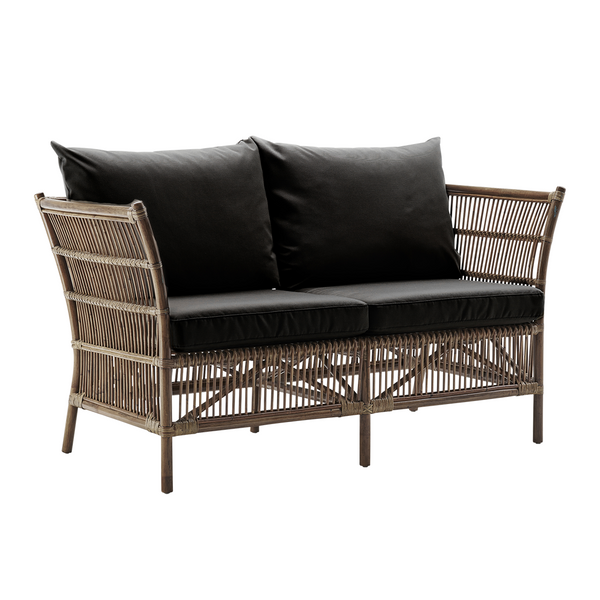 Textured gray wicker loveseat with two black cushions, showcasing a modern and stylish pattern. Ideal for outdoor spaces.