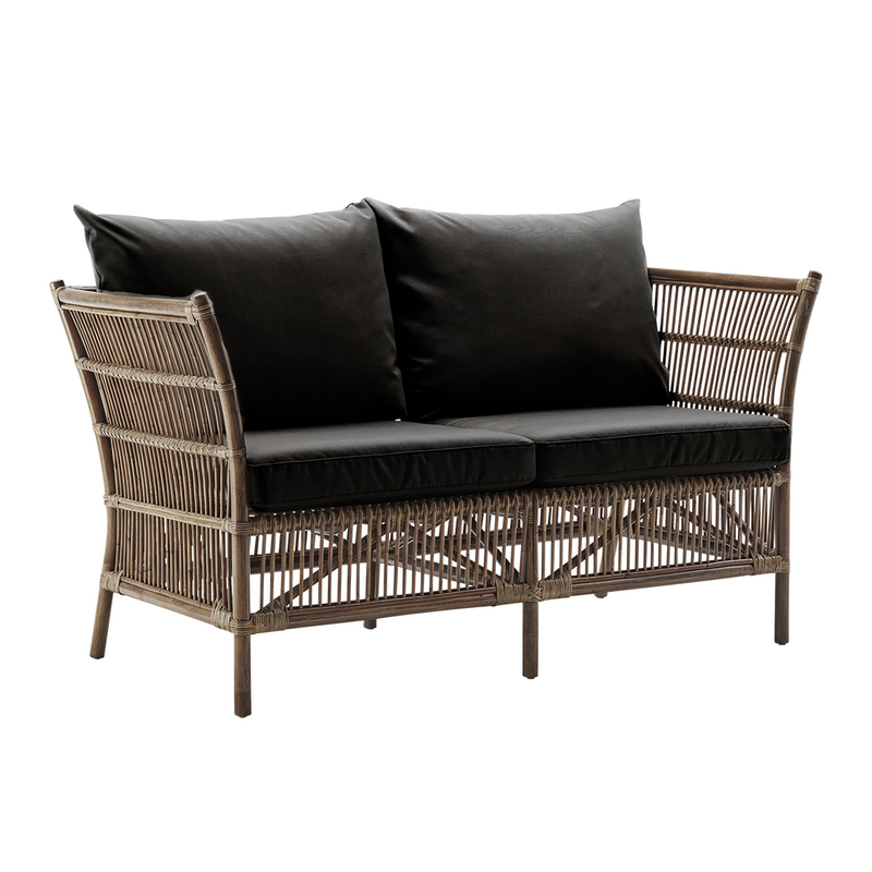 Textured gray wicker loveseat with two black cushions, showcasing a modern and stylish pattern. Ideal for outdoor spaces.