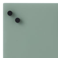 Soft mint green surface with two black circular knobs, minimalistic design and smooth finish.