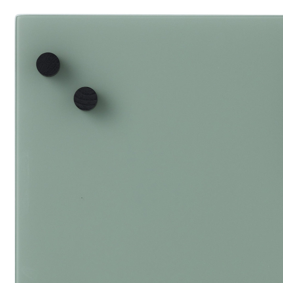 Textured mint green surface with two black round knobs. Modern and minimalist design, perfect for contemporary decor.