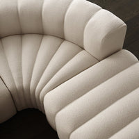 Beige curved couch with tufted wave pattern, showcasing a modern and inviting texture. Perfect for stylish interiors.
