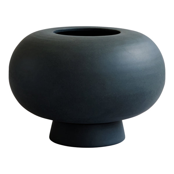 Round black vase with a smooth matte finish and a sculptural design, featuring a wide base and circular opening.