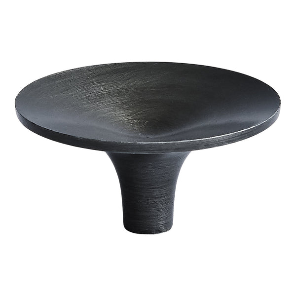 Black decorative dish with smooth, matte finish and subtle metallic sheen on a round surface.