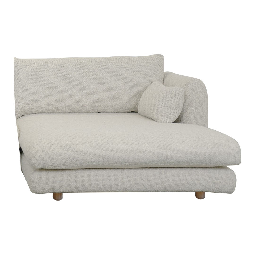 Cream-colored chaise lounge with a textured fabric and simple, modern design, featuring wooden legs and a round cushion.