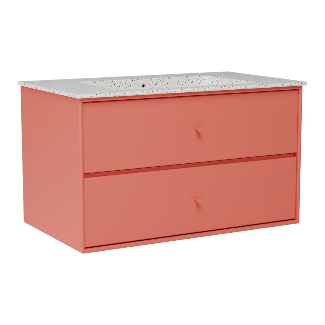 Coral pink dresser with a textured white countertop and simple drawer pulls, featuring a modern, minimalist design.