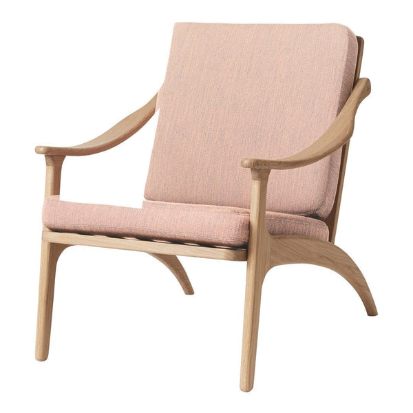 Light pink upholstered chair with a textured pattern and natural wood frame, perfect for modern decor.