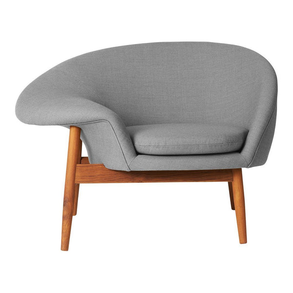 Stylish gray upholstered armchair with smooth curves and natural wood legs, perfect for modern decor.