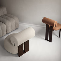 Neutral beige and brown round upholstered chairs with dark wooden bases, set against a light gray background.