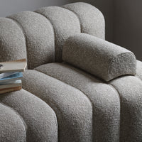 Textured beige fabric sofa with curved lines and a cozy, soft bolster cushion. Perfect for modern living spaces.