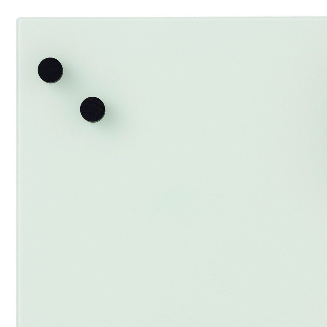 Light green board with smooth surface featuring two black round magnets. Ideal for note-taking and reminders.