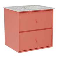 Coral pink storage cabinet with a speckled white top and two drawers, featuring simple round knobs.