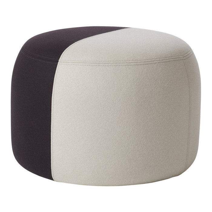 Modern round pouf featuring a two-tone design in soft beige and deep black. Perfect for chic decor.