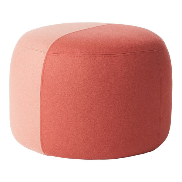 Round ottoman in coral and soft pink with a modern, geometric two-tone pattern for stylish interior decor.