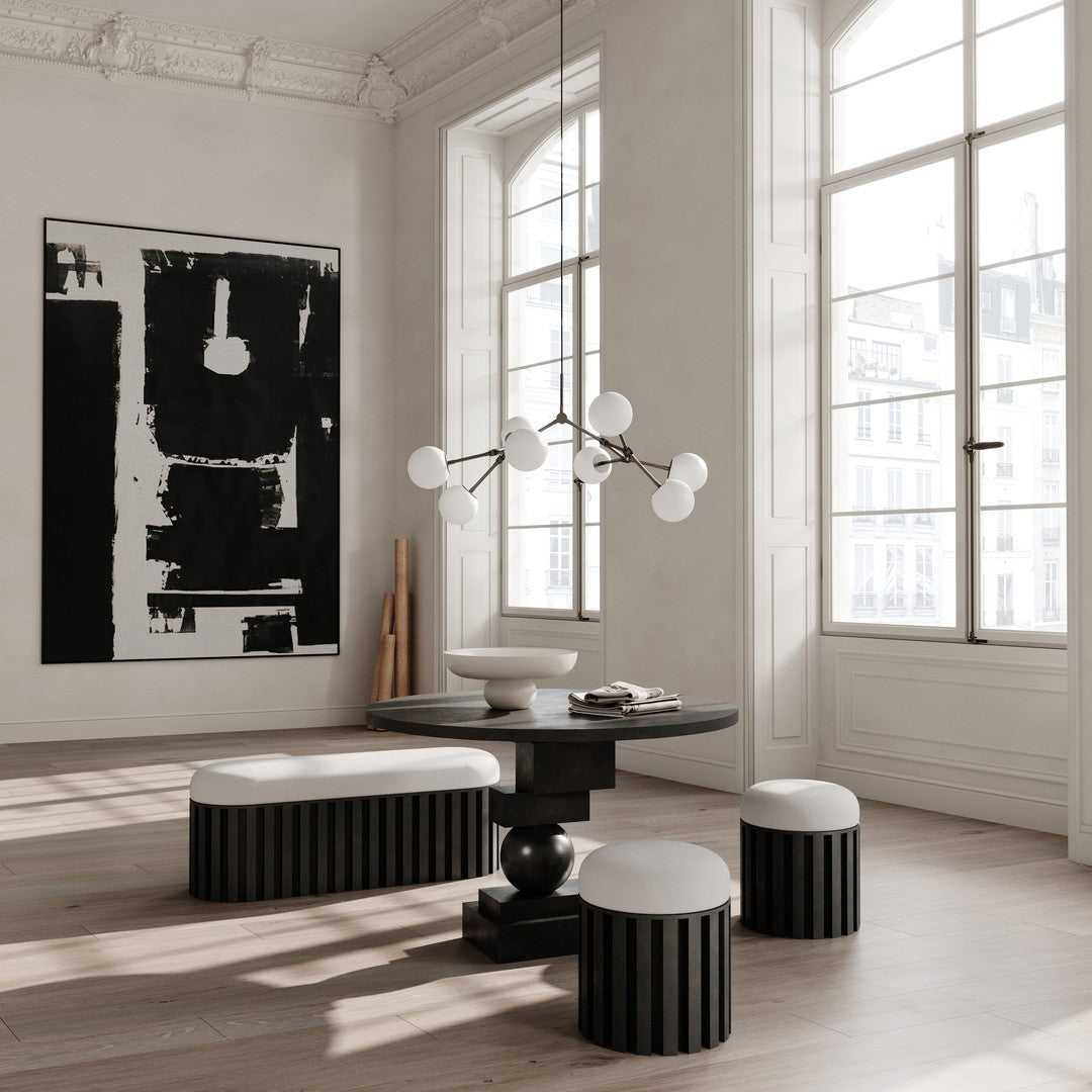Monochrome black and white room featuring striped seating and a sleek, modern chandelier. Elegant and minimalistic design.