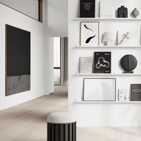 Modern interior featuring a sleek black and white color palette with minimalist patterns and natural wood tones.