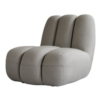 Light gray modern chair with soft fabric, featuring a smooth, minimalistic design and rounded, ribbed patterns.