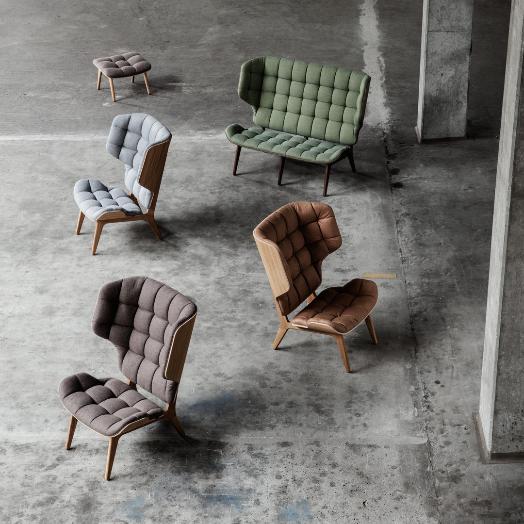 "Collection of tufted chairs in gray, green, brown, and beige, showcasing modern design and unique patterns."