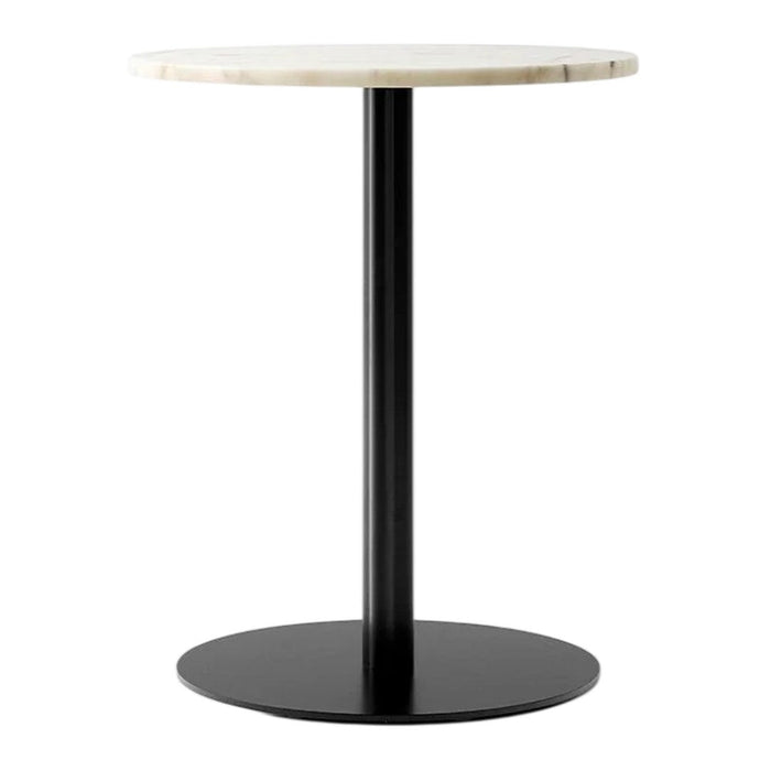 Round marble tabletop in cream with a sleek black metal base, minimalist design, and modern aesthetic.