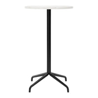 Round white tabletop on a sleek black metal base, featuring a minimalist and modern design. Perfect for any decor.