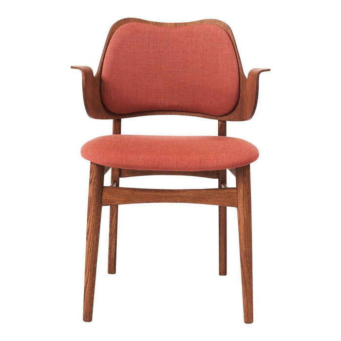 Mid-century modern chair in a warm coral fabric with a textured pattern on wooden legs. Stylish and elegant design.