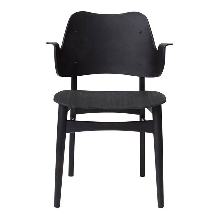 Black wooden chair with a minimalist design and smooth, curved lines. Ideal for modern decor.