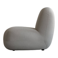Gray curved lounge chair with a sleek, minimalist design and smooth fabric surface. Perfect for modern interiors.