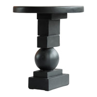 Black minimalist side table featuring geometric shapes with a matte finish. Ideal for modern decor.