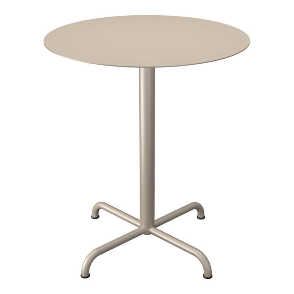 Round beige table with a smooth surface and a minimalist design, featuring a sleek metal base and four sturdy legs.