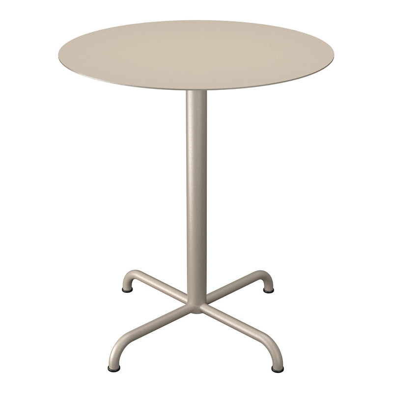 Round beige table with a smooth surface and a minimalist design, featuring a sleek metal base and four sturdy legs.
